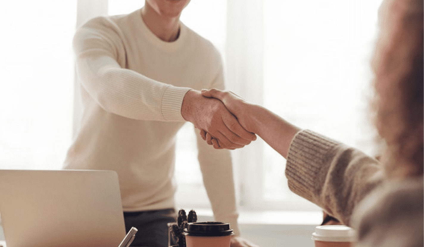A man shaking a hand with a client.